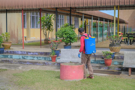 Muadzam Shah-Malaysia - June 22th, 2020 : Disinfectant worker in protective suit making disinfection...