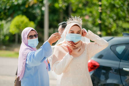 Muadzam Shah, Malaysia - June 17th,  2020 : A muslim couple getting solemnization  in medical face masks during coronavirus pandemic. COVID-19 weddings. Social Distancing .のeditorial素材