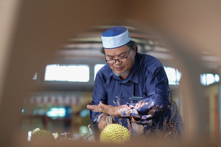 Muadzam Shah, Malaysia - June 25th,2020:  Happy asian men enjoy eating durian fruit with thier friends.のeditorial素材
