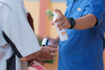 Muadzam Shah, Malaysia - June 29th, 2020: New normal, Business people team using hand sanitizer, healthcare and covid-19 prevention conceptのeditorial素材