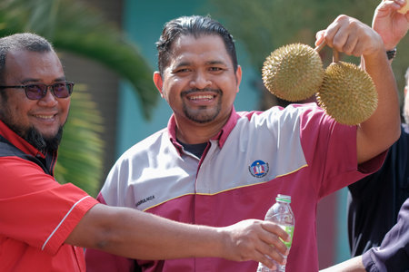 Muadzam Shah, Malaysia - July 1st ,2020:  Happy asian men enjoy eating durian fruit with thier friends.のeditorial素材
