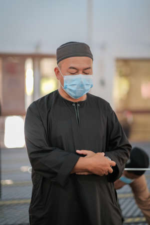 Muadzam Shah, Malaysia - July 3rd, 2020 : Muslims performed the Friday Prayer at Muadzam Shah Mosque during Covid-19 pandemic. Maintaining Social distancing guidelines.のeditorial素材