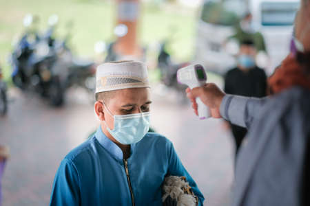 Muadzam Shah, Malaysia - July 3rd, , 2020 : Muslims performed the Friday Prayer at Muadzam Shah Mosque during Covid-19 pandemic. Temperature screening and maintaining Social distancing guidelines.のeditorial素材