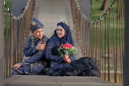 Malay couple wedding ceremony. Love each other. The bride and groom are doing romantic pose at the beach during their wedding photo session.の写真素材
