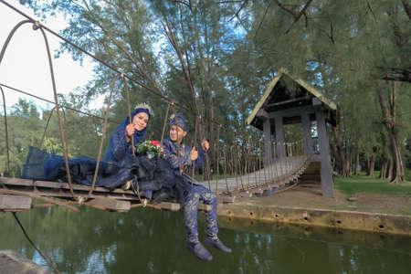 Malay couple wedding ceremony. Love each other. The bride and groom are doing romantic pose at the beach during their wedding photo session.の写真素材