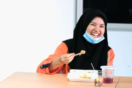 Muadzam Shah, Malaysia - June 25th, 2020 : Student  eating food in the classroom. Social distancing. Concept protection of corona virus or covid-19.のeditorial素材