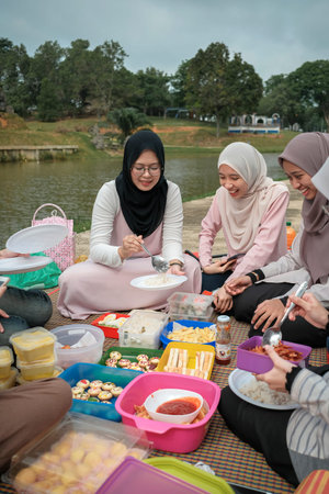 Photo of happy schoolmates or reunion, have picnic together during sunny day and  have pleasant...