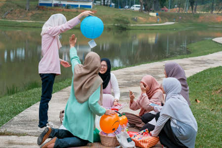 Photo of happy schoolmates or reunion, have picnic together during sunny day and  have pleasant talk. Togetherness and lifestyle conceptのeditorial素材