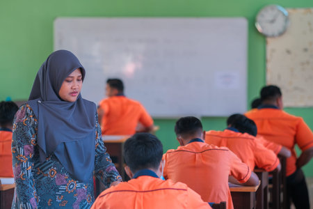 Muadzam Shah, Malaysia - July 8th,2020: Muslim teacher smiling to her student who answer the...