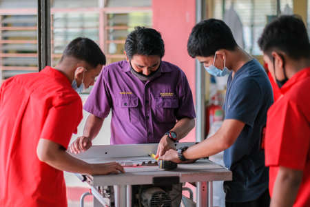 Muadzam Shah- July 14th, 2010 : Carpenter working with circular saw at carpentry workshopのeditorial素材