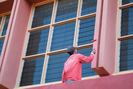 Muadzam Shah, Malaysia- July 15th, 2020 : Unrecognizable painter working painting  without Personal Protective Equipment (PPE)  . Worker concept.のeditorial素材