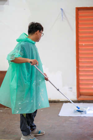 Muadzam Shah, Malaysia - July 22th , 2020 : Painter with disposable overalls coveralls hood painters decorator suit protective working in the hall .のeditorial素材