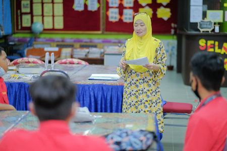 Muadzam Shah, Malaysia _ August 12th, 2020: Teacher and students studying in the library together