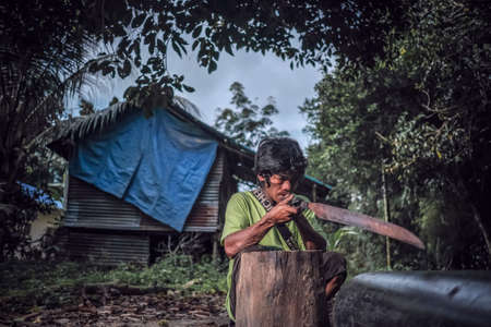 Muadzam Shah, Malaysia - August 18th, 2020 : Indigenous Malaysian aboriginal craftman making a knife  for hunting.のeditorial素材