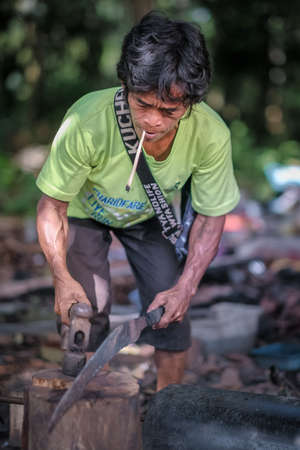 Muadzam Shah, Malaysia - August 18th, 2020 : Indigenous Malaysian aboriginal craftman making a knife  for hunting.のeditorial素材