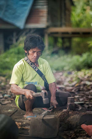 Muadzam Shah, Malaysia - August 18th, 2020 : Indigenous Malaysian aboriginal craftman making a knife  for hunting.のeditorial素材