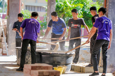 Besut, Malaysia - September 8th, 2020 : College students  working brick wall construction in bricklaying workshopのeditorial素材
