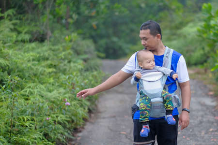 Muadzam Shah, Malaysia - September 13th, 2020 : Hiking family  having food at a  top of Ridan Hill  in Muadzam Shah, Malaysia. Family hiking on vacation.のeditorial素材