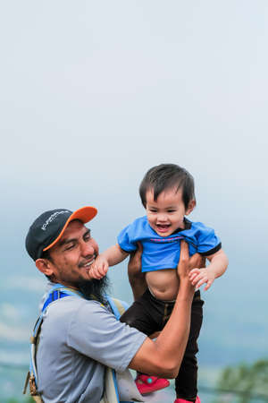 Muadzam Shah, Malaysia - September 13th, 2020 : Hiking family  having food at a  top of Ridan Hill  in Muadzam Shah, Malaysia. Family hiking on vacation.のeditorial素材