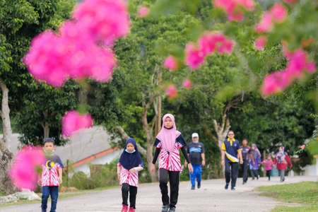 Muadzam Shah, Malaysia -   September 16th, 2020 : People walking and jogging together outdoors along a  road during Malaysia Dayのeditorial素材