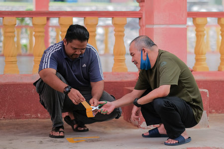 Muadzam Shah, Malaysia -  June  23th, 2020 : Men making arrows and taped stripes to assure social...