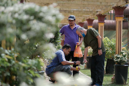 Muadzam Shah, Malaysia -  June  23th, 2020 : Men making arrows and taped stripes to assure social distancing. Secure marking of lines on floor for directionsのeditorial素材