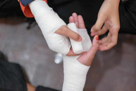 Student first aid training in the hall. Student trying to splint the hand  of a patient's broken...