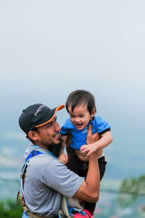 Muadzam Shah, Malaysia - September 13th, 2020 : Hiking family  having food at a  top of Ridan Hill  in Muadzam Shah, Malaysia. Family hiking on vacation.のeditorial素材