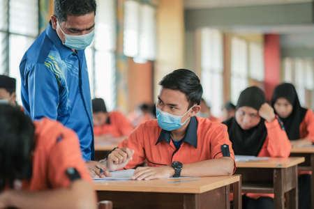 Muadzam Shah, Malaysia - October 1st,  ,2020 : Muslim teacher smiling to her student who answer the questionのeditorial素材