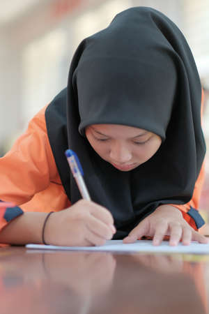 Muadzam Shah, Malaysia - October 5th, 2020 :  Young college student in chemistry class, writing notes. Focused student in classroom. .Education conceptのeditorial素材