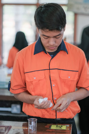 Muadzam Shah, Malaysia - October 5th, 2020 : Asian students learning and doing a chemical experiment...