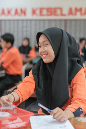 Muadzam Shah, Malaysia - October 5th, 2020 :  Young college student in chemistry class, writing notes. Focused student in classroom. .Education conceptのeditorial素材