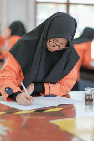 Muadzam Shah, Malaysia - October 5th, 2020 :  Young college student in chemistry class, writing notes. Focused student in classroom. .Education conceptのeditorial素材