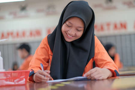 Muadzam Shah, Malaysia - October 5th, 2020 :  Young college student in chemistry class, writing notes. Focused student in classroom. .Education conceptのeditorial素材