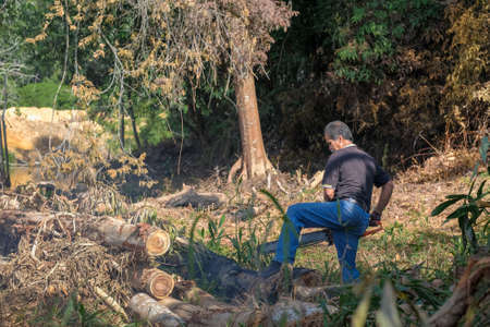 Muadzam Shah, Malaysia - October 18th,2020:   Residents helping each other in a teamwork spirit in clearing and cleaning the lakeside area . People doing landscaping works .のeditorial素材