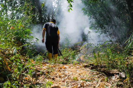 Muadzam Shah, Malaysia - October 18th,2020:   Residents helping each other in a teamwork spirit in clearing and cleaning the lakeside area . People doing landscaping works .のeditorial素材