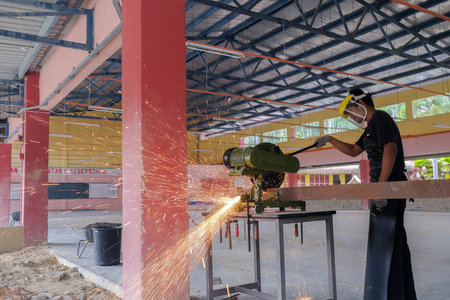Muadzam Shah, Malaysia - October 14th,2020:  Young man using disc cutter  to metal plate , tools for industrial and construction.のeditorial素材