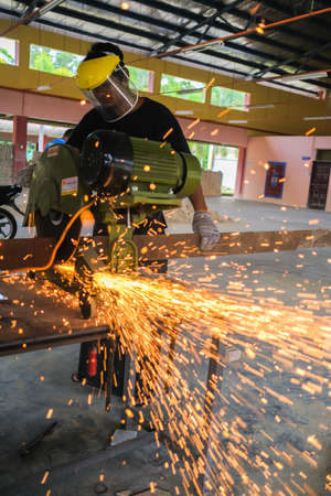 Muadzam Shah, Malaysia - October 14th,2020:  Young man using disc cutter  to metal plate , tools for industrial and construction.のeditorial素材