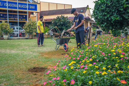 Muadzam Shah, Malaysia - October 14th,2020:  Workers digging hole for stump concrete foundation holderのeditorial素材