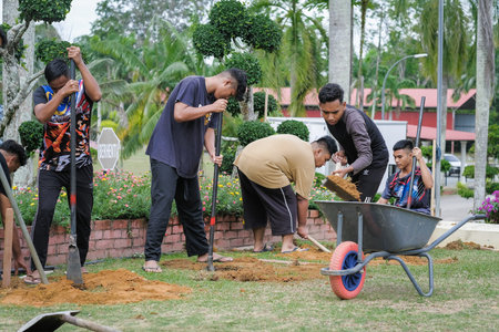 Muadzam Shah, Malaysia - October 14th,2020:  Workers digging hole for stump concrete foundation holderのeditorial素材