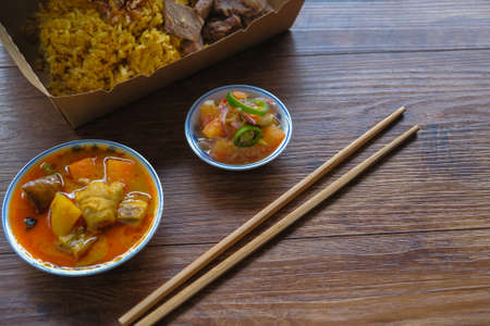 Roasted meat served with rice , dalca and sour sauce . This food is well-known in the Northern Peninsular Malaysia known as " Nasi Daging Air Asam"の写真素材