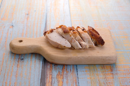 Sliced fried   chicken on wooden cutting boardの写真素材