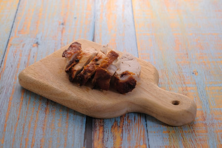 Sliced fried   chicken on wooden cutting boardの写真素材