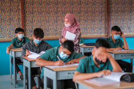 Muadzam Shah, Malaysia - January 20th, 2021 : Teacher and  student  with face mask back at school after school holiday in MCO 2.0 - COVID-19.のeditorial素材