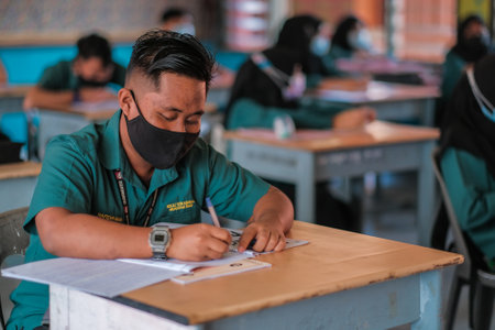 Muadzam Shah, Malaysia -January 20th,2021: Malaysian students wear face shields and facemasks in classroomfor protect from Covid -19. New normal education.のeditorial素材
