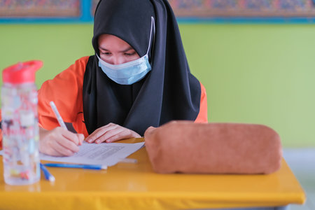 Muadzam Shah, Malaysia -January 20th,2021: Malaysian students wear face shields and facemasks in classroomfor protect from Covid -19. New normal education.のeditorial素材