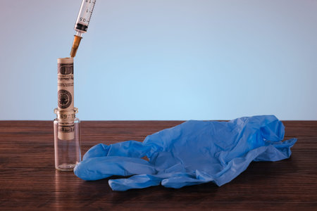 Syringe , glove, bottle and money in budget cost money concept spend to health with light blue...