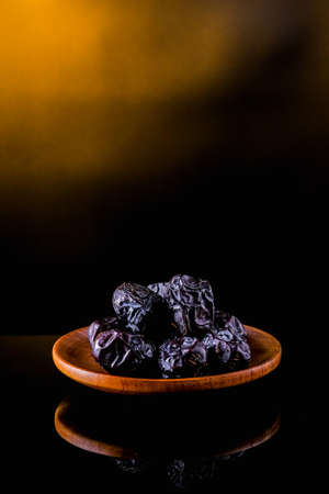 Ajwa Al-Madina dates fruits on a black table.の写真素材