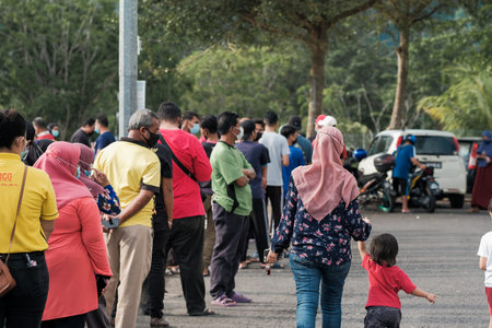Muadzam Shah , Malaysia - April 24th, 2021 :  People queue up to buy food at ramadan bazaar stall in...