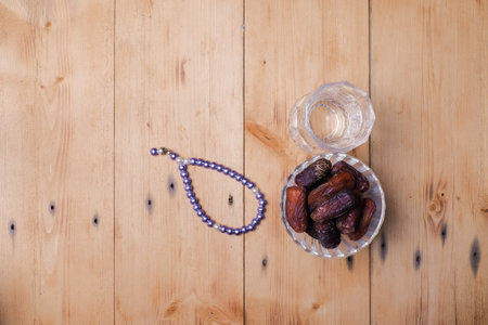 Traditional Islamic Ramadan or Ramazan Iftar food. Flat-lay of dates and fresh drinking water  on wooden  background, top view. Ramadan muslim fasting monthの写真素材